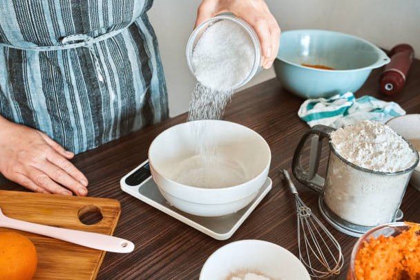 Kitchen scale with flour and ingredients for metric baking
