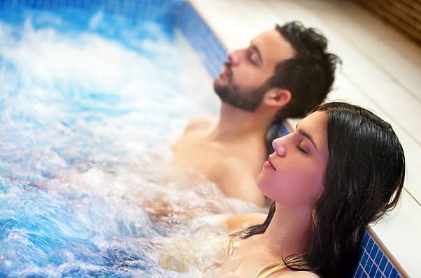 Couple relaxing in hot tub