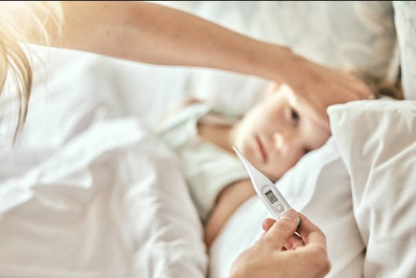 Taking temperature of a sick child