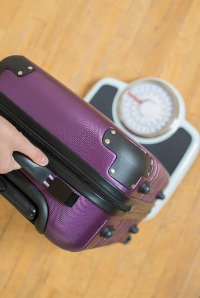 Suitcase on weighing scale for travel
